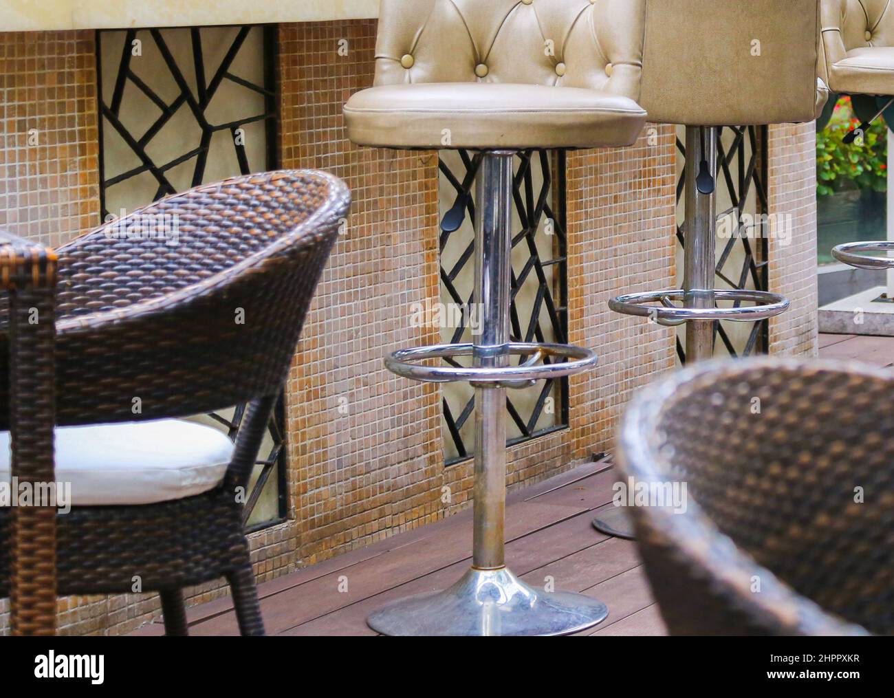 Restaurant terrace rattan bamboo chairs with white cushions and