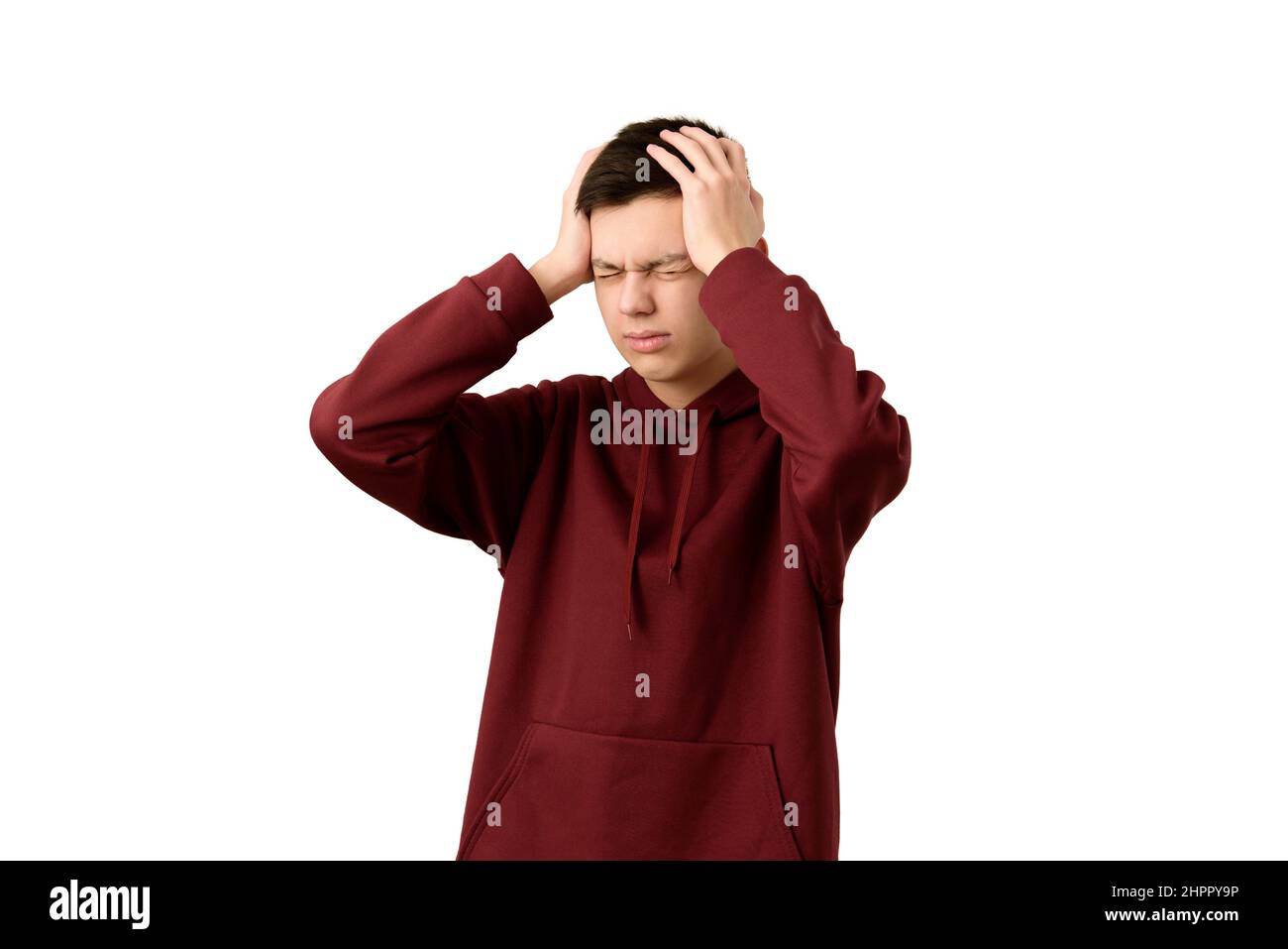 Handsome teenage boy suffering from headache or migraine, isolated on