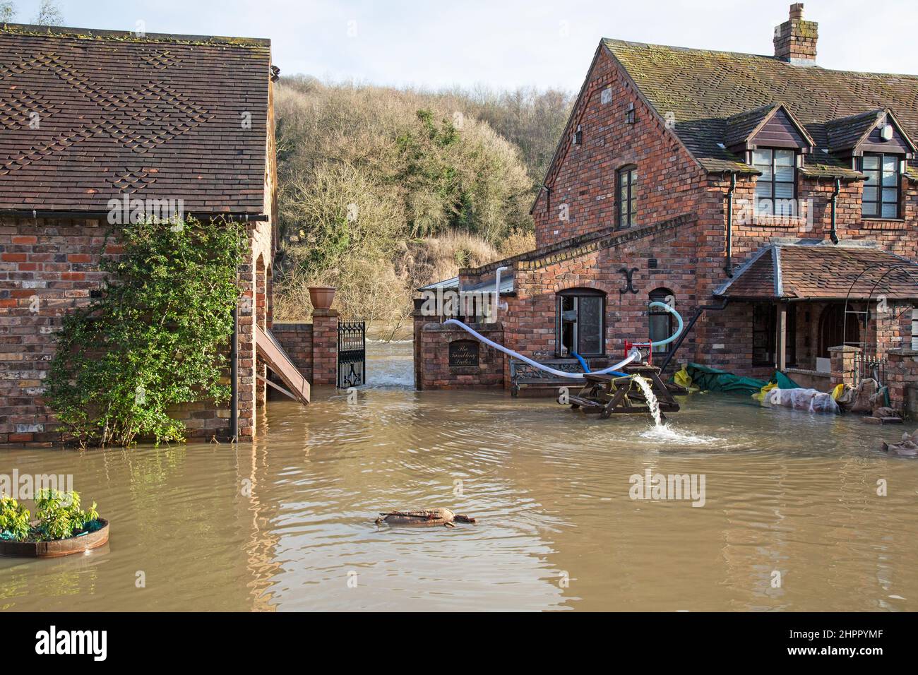 Jackfield, Shropshire, 23/02/2022, The village of Jackfield in the Ironbridge Gorge World Heritage Site in Shropshire, England, is once again experiencing severe flooding, only two years after the last major flooding event. After a week of storms and severe rain, the River Severn in Shropshire is once again nearing record flood levels. Some riverside properties are having to try to pump as much water out of the buildings as possible, but river levels are predicted to remain high for the next couple of days. Stock Photo