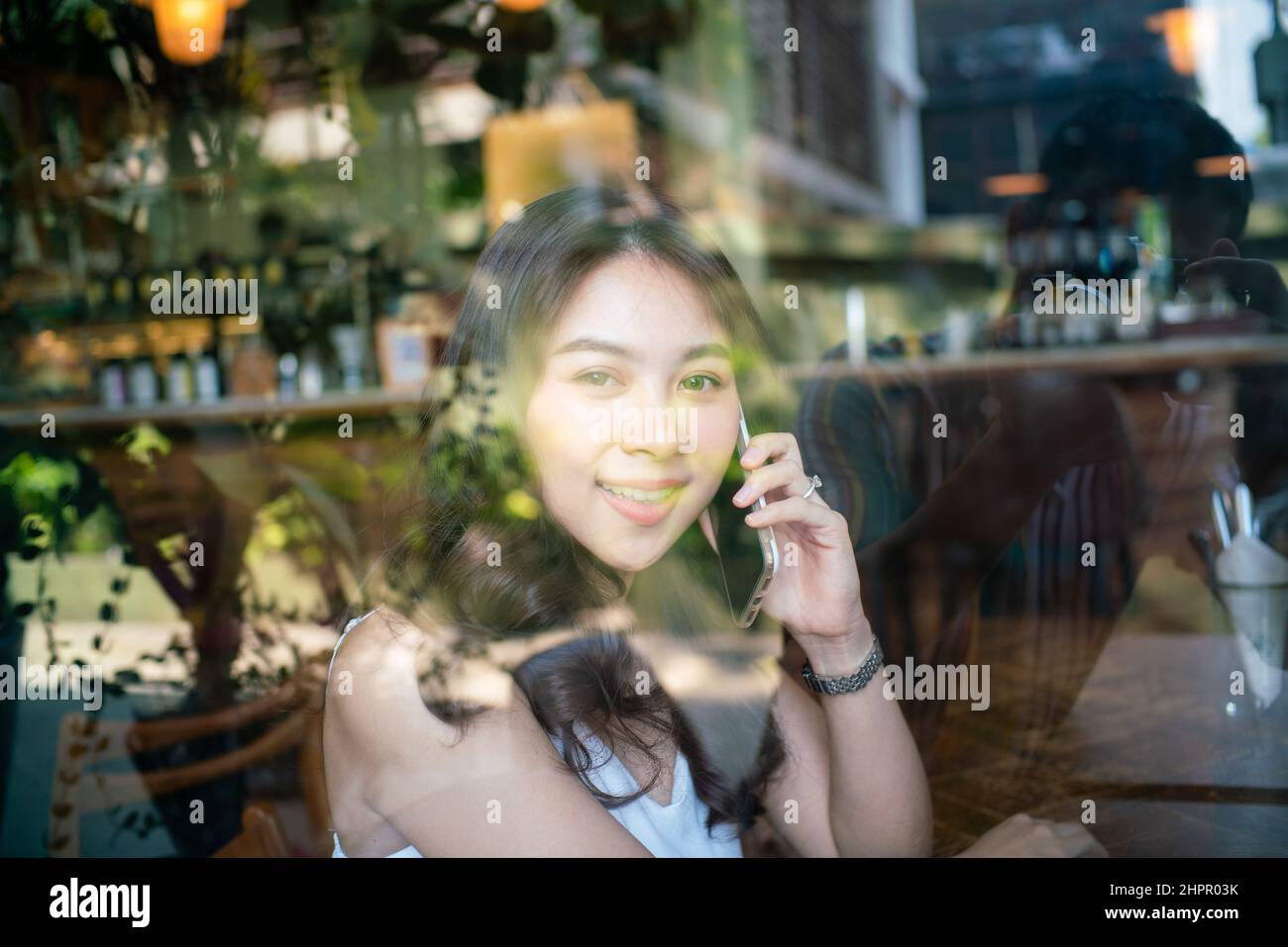 Business asian women use smartphone sitting in coffee shop day light ...