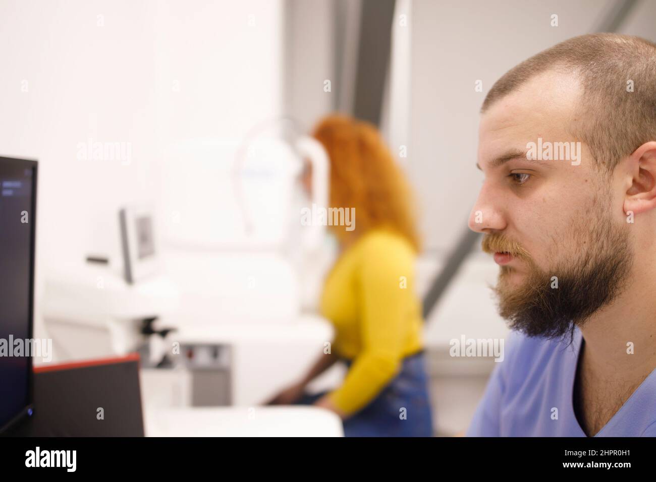 Optometry specialist looking at data from her patient with eyesight problems Stock Photo