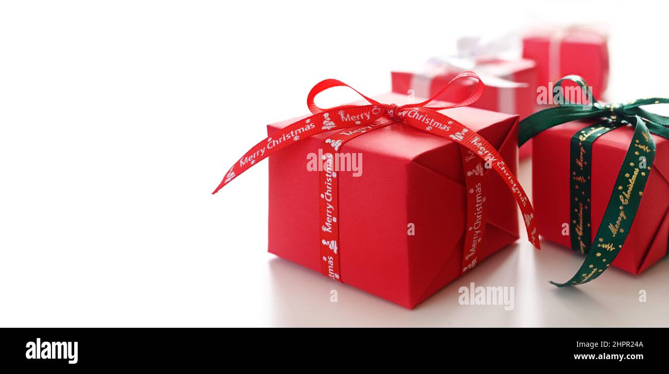 Christmas gifts wrapped in red wrapping paper Side view. Copy space