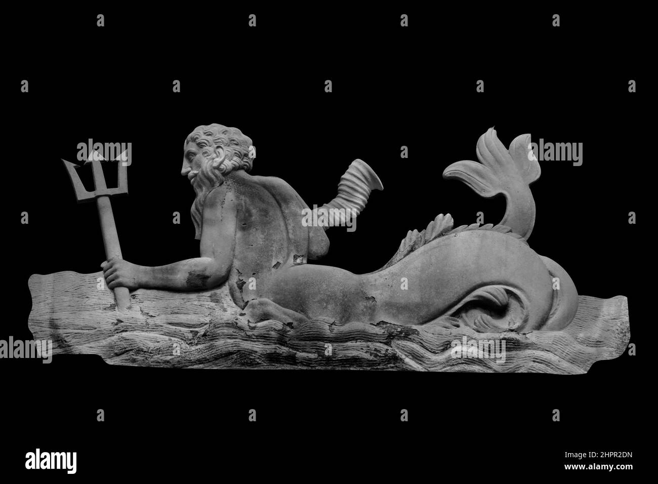 The mighty god of the sea and oceans Neptune (Poseidon) The ancient statue isolated on black background. Black and white image. Stock Photo