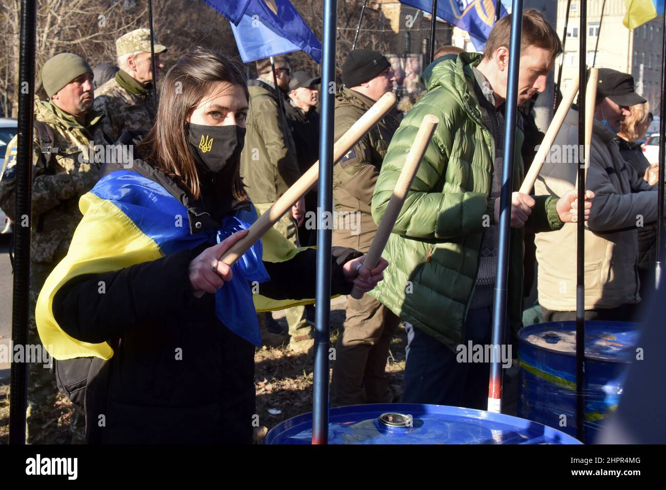 Non Exclusive: KYIV, UKRAINE - FEBRUARY 22, 2022 - A girl with a Ukrainian  flag on her shoulders beats a burn barrel during the Empire Had to Die rall  Stock Photo - Alamy