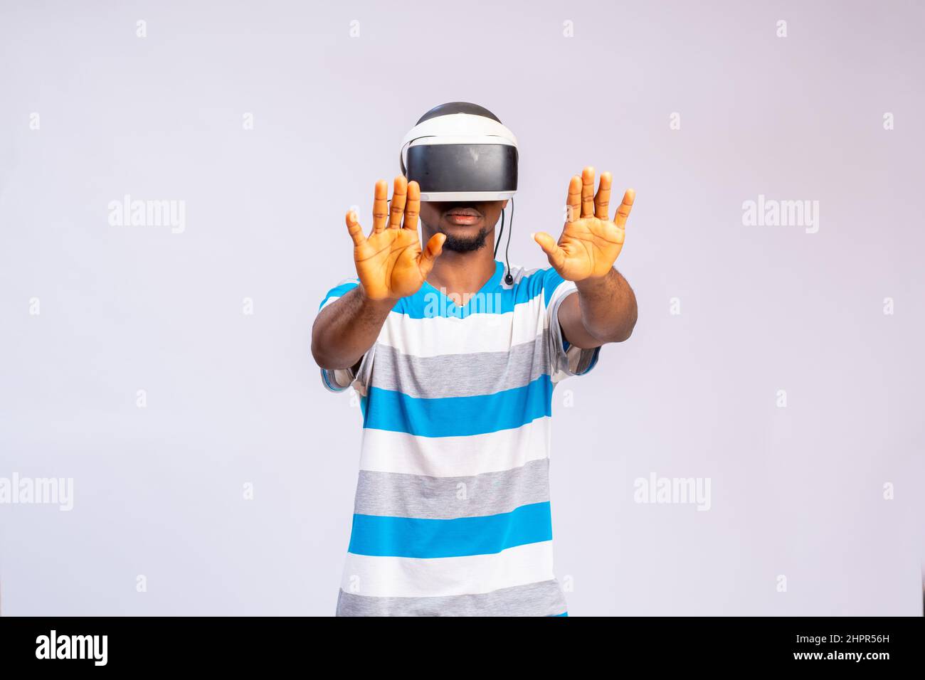 Handsome African man using VR glasses. Virtual reality experience. Stock Photo