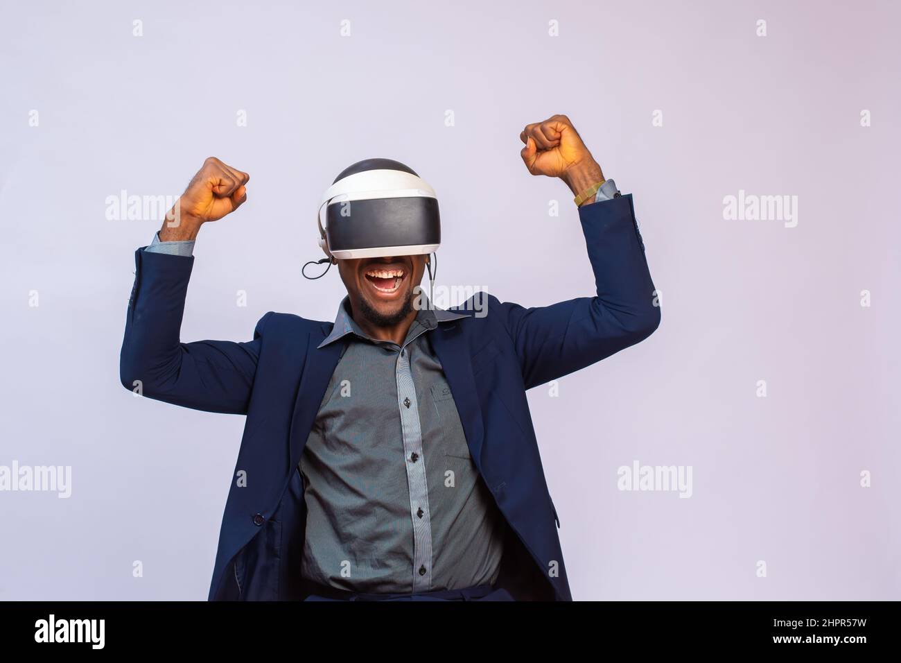 Handsome African man in a costume using VR glasses. Virtual reality ...