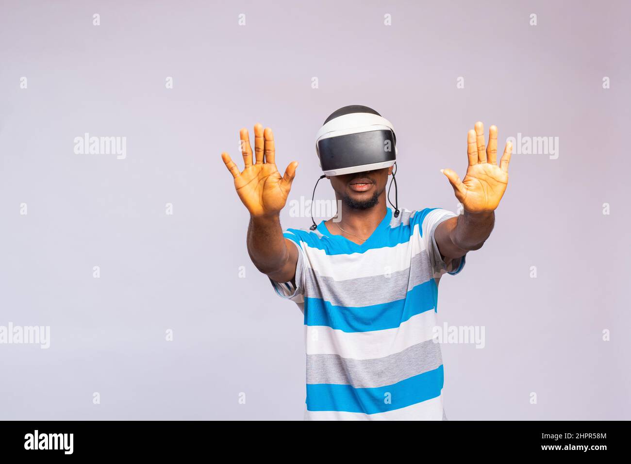 Handsome African man using VR glasses. Virtual reality experience. Stock Photo