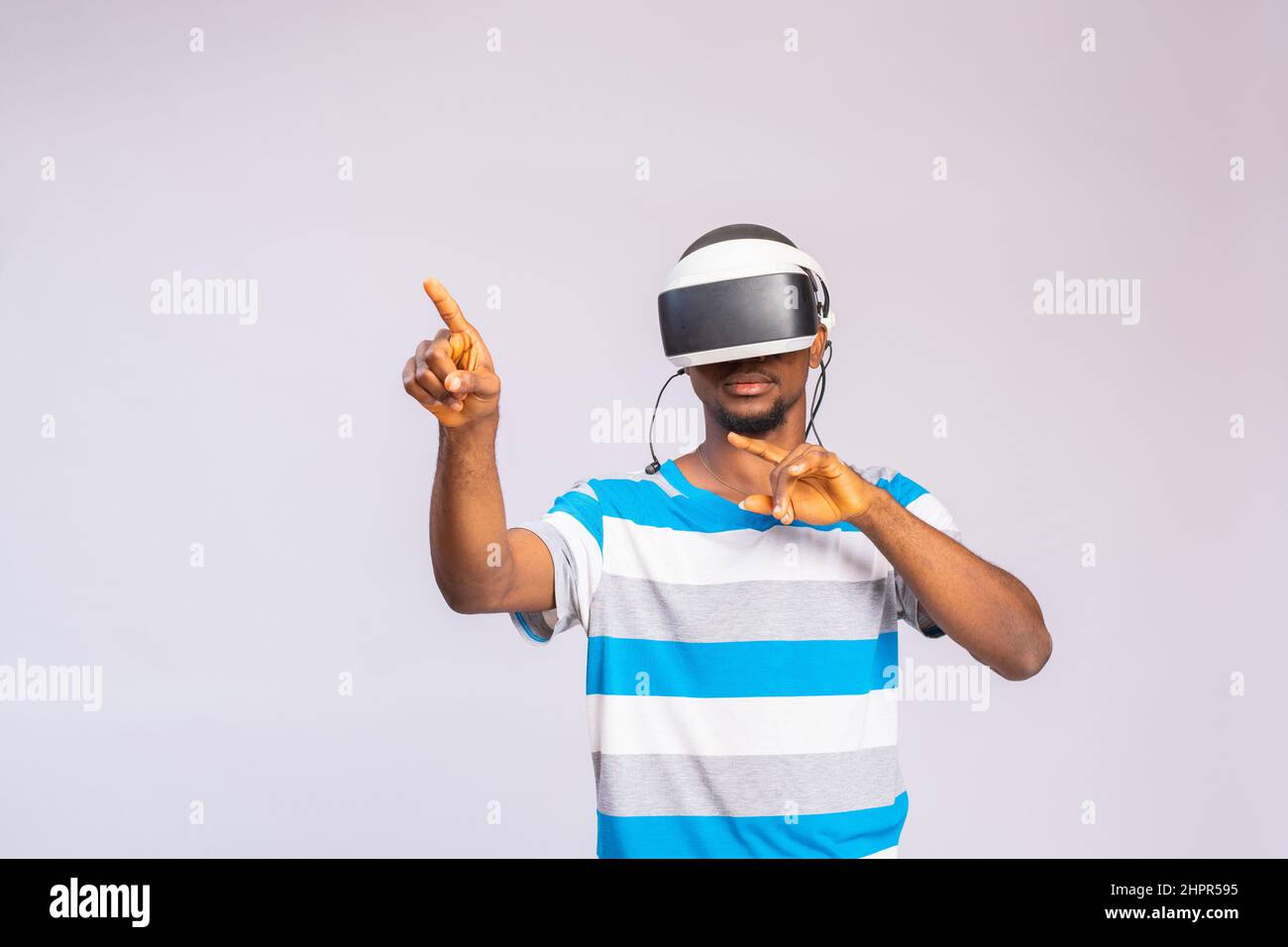 Handsome African man using VR glasses. Virtual reality experience. Stock Photo