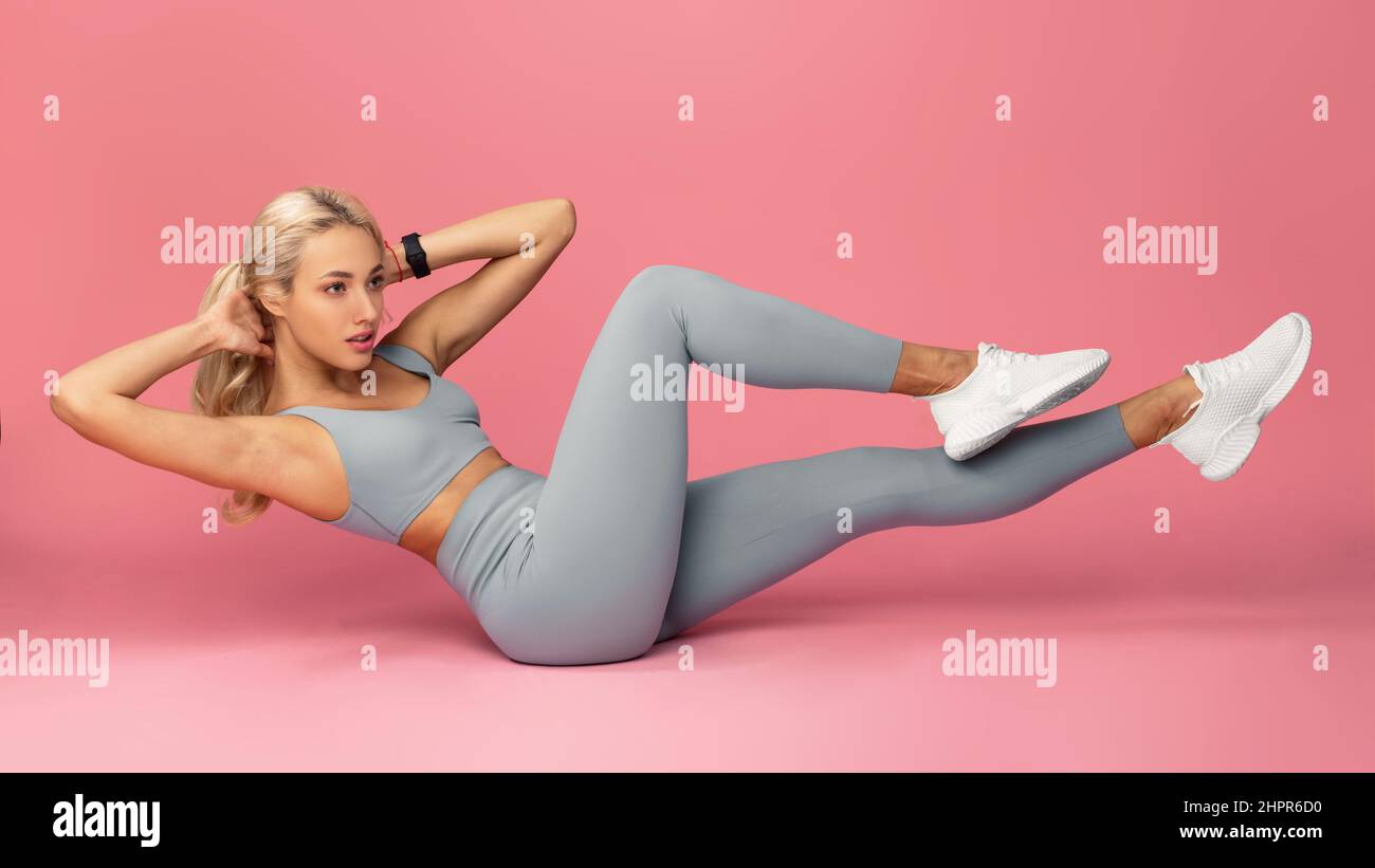Young Woman Doing Abs Exercise, Side Crunches Stock Photo