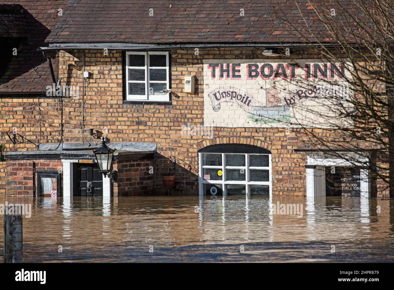 Shropshire, England. 23/02/2022, The Boat Inn, in the village of Jackfield in the Ironbridge Gorge World heritage site in Shropshire, is always one of the first victims when the River Severn bursts its banks in the area. Flood levels are recorded on the outside of the old entrance way. Once agin, after a week of severe storms, the pub finds itself underwater once again. Stock Photo