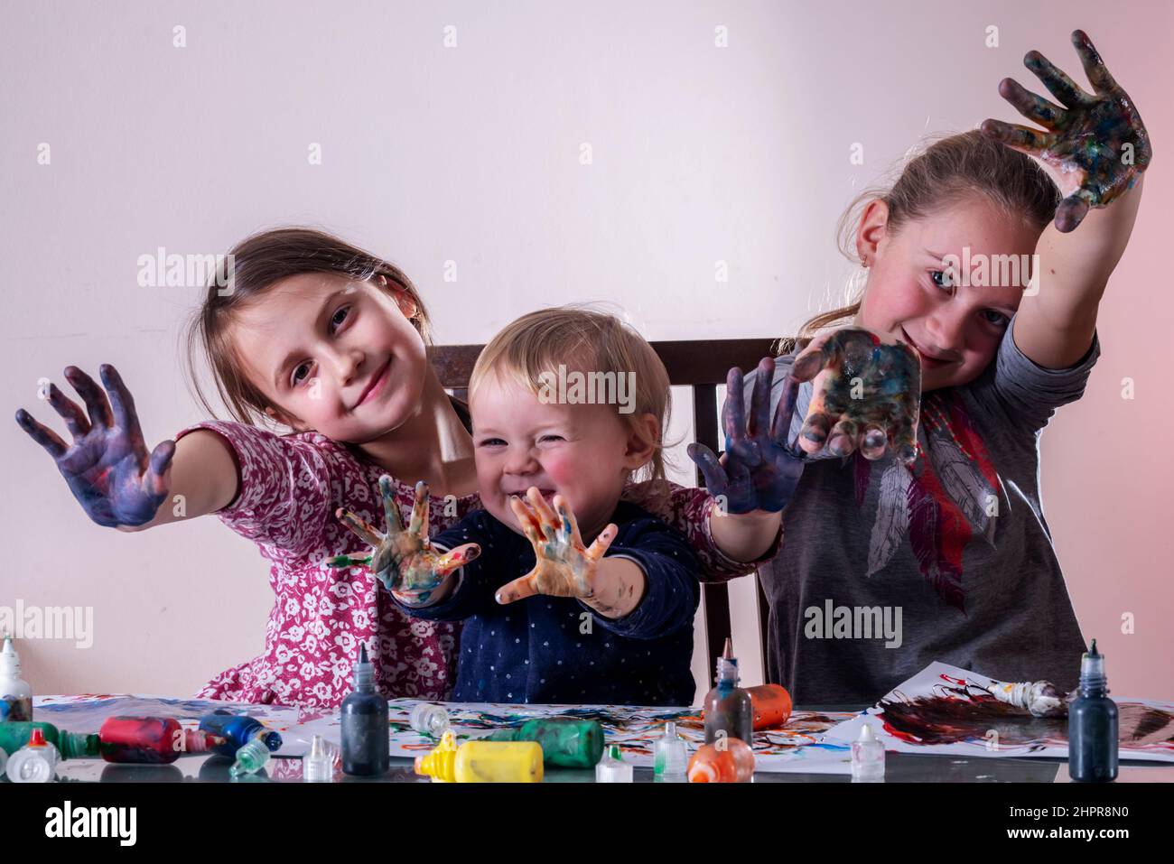 Happy little children with painted hands drawing and having fun ...