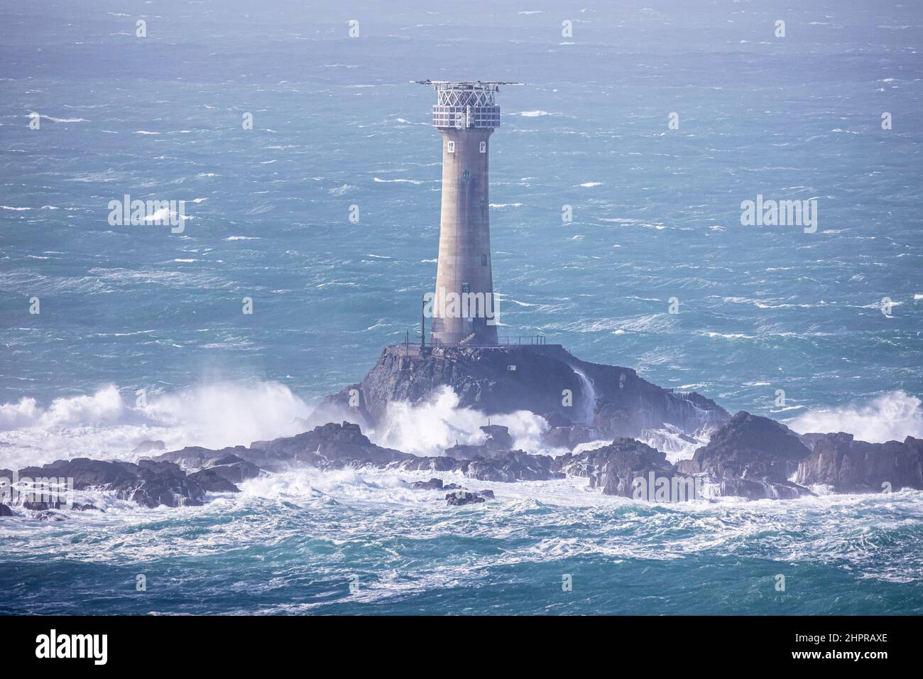 Longships Lighthouse, Lands End, Cornwall.  Photographed during a brisk north westerly gale at low tide Stock Photo