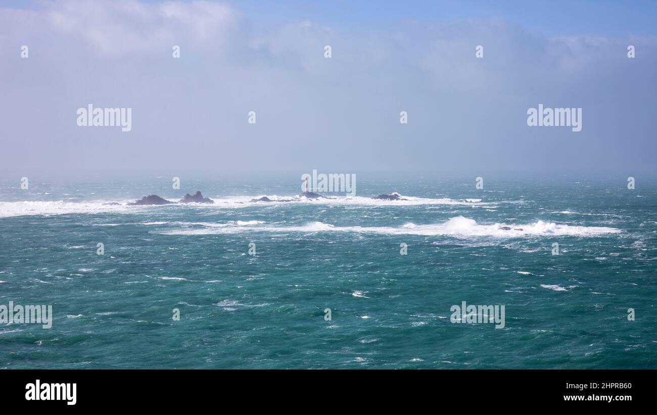 Longships Lighthouse and reef as seen from Lands End during a north west gale Stock Photo