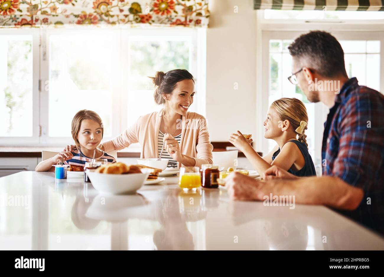 Sharing stories at the breakfast table. Cropped shot of a family enjoying breakfast together. Stock Photo