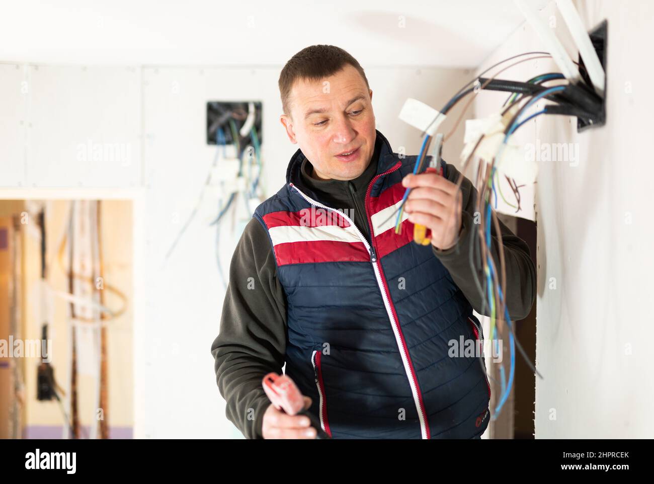 Electrician working with wires in apartment Stock Photo Alamy
