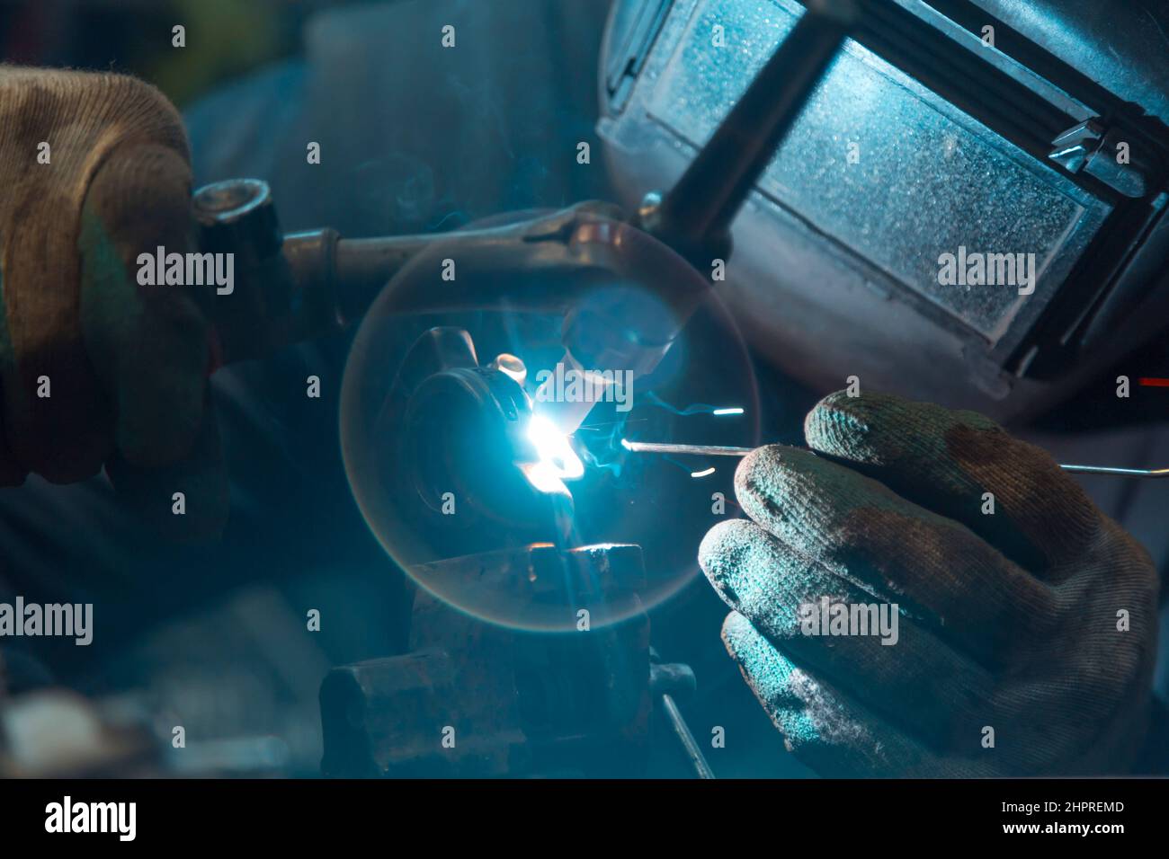 TIG welder welds an aluminum part of a car Stock Photo Alamy