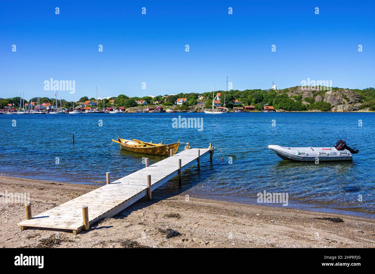 Two boats at a landing stage on the North shore of the South Koster Island with a beautiful view of the North Koster Island, Sweden. Stock Photo