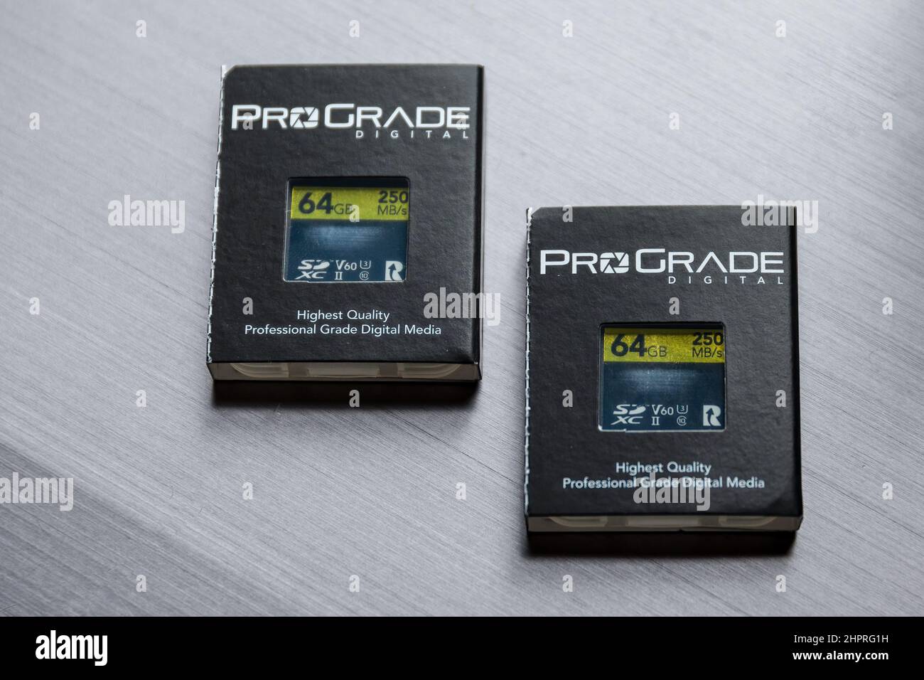 Two ProGrade SD cards, with packaging, on a silver background Stock Photo