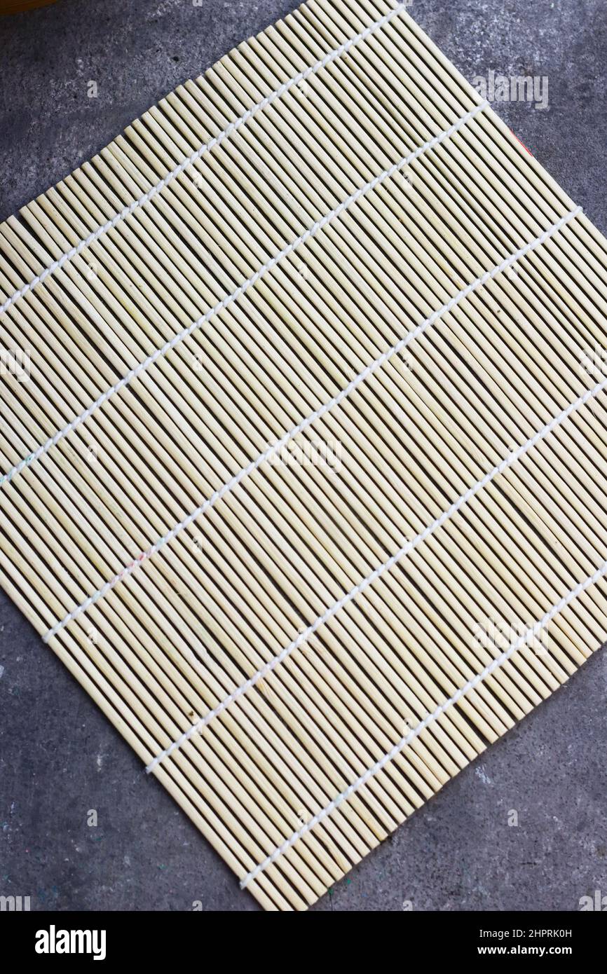 Sushi Roller mat on grey grainy background. Stock Photo