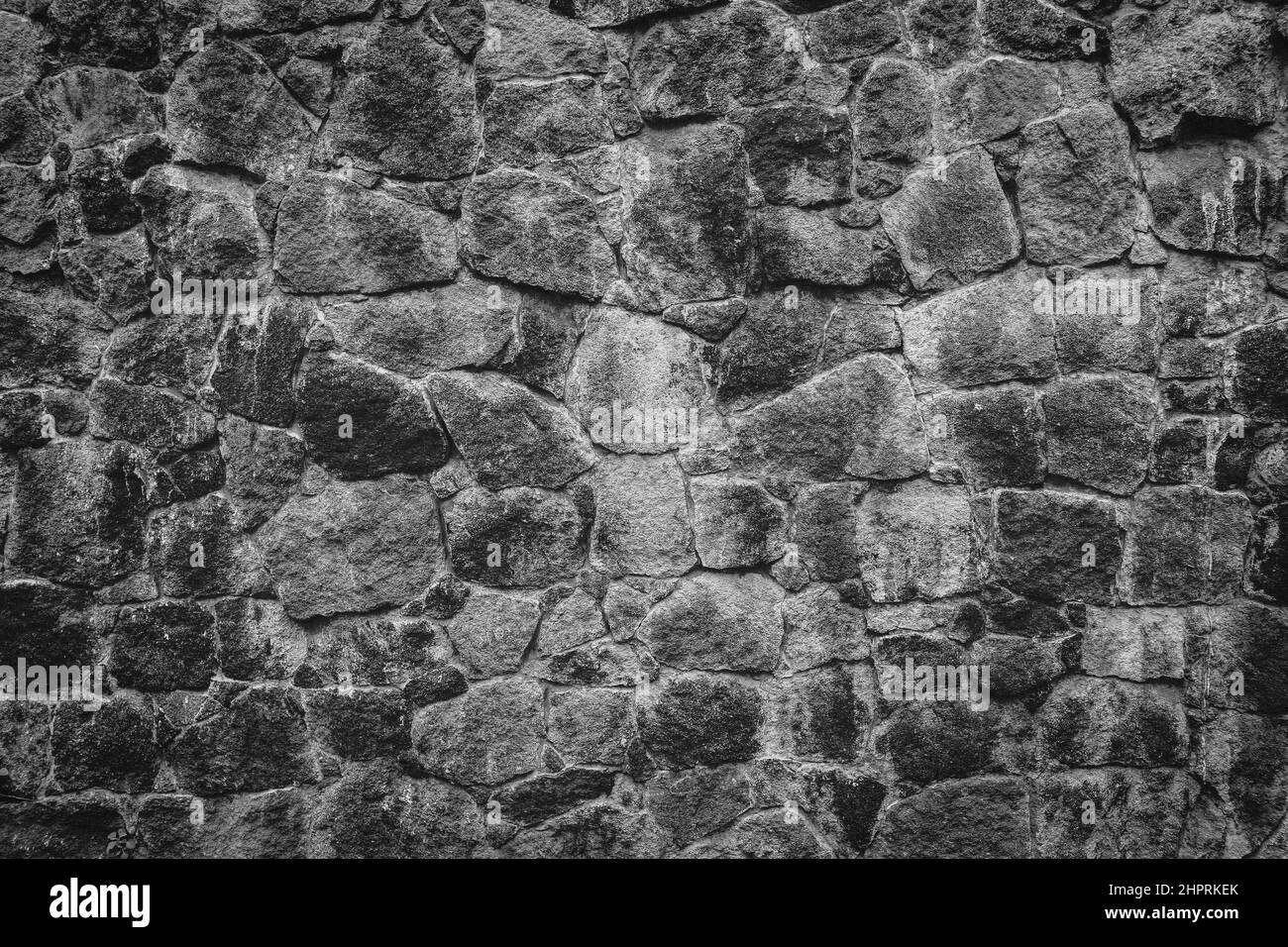 Abstract traditional stone wall pavement texture background. Bumpy textured stonewall made from flagstone and slabstone. Stock Photo