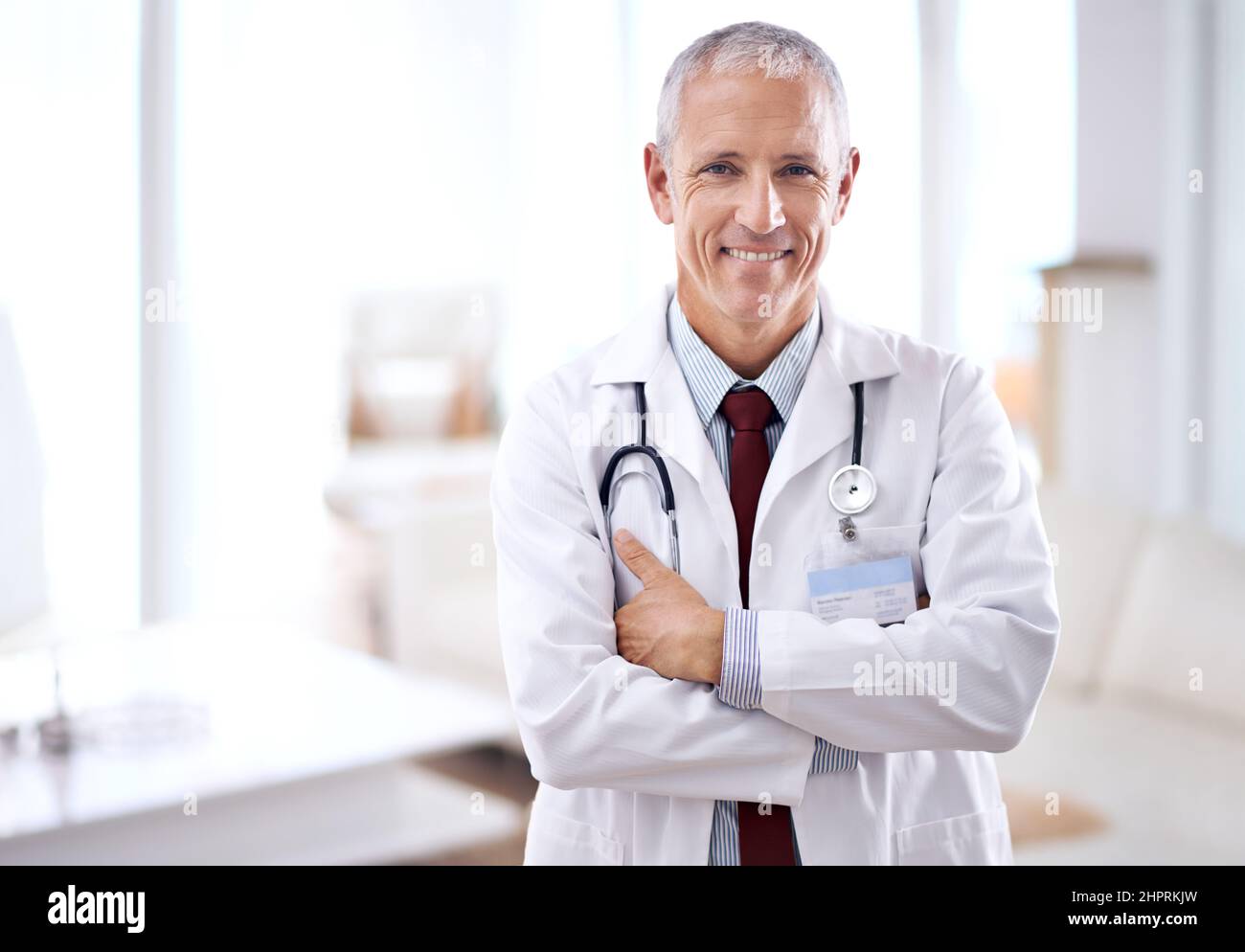 Ive got some good news. Portrait of a mature medical doctor smiling at ...