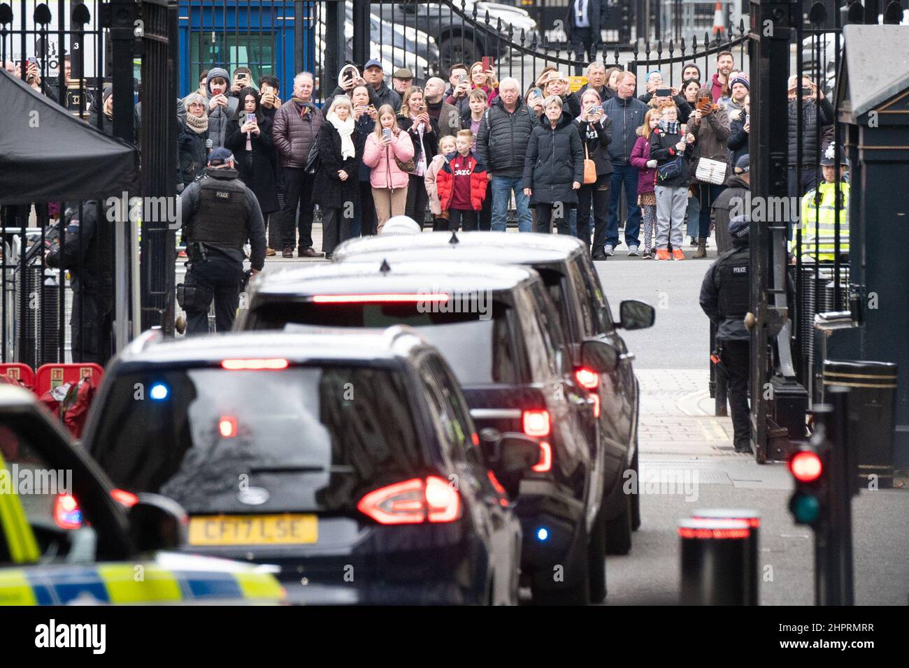 Members of the public watch as Prime Minister Boris Johnson's motorcade leaves 10 Downing Street, London on it's way to the Houses of Parliament where the Prime Minister will face PMQs. Stock Photo