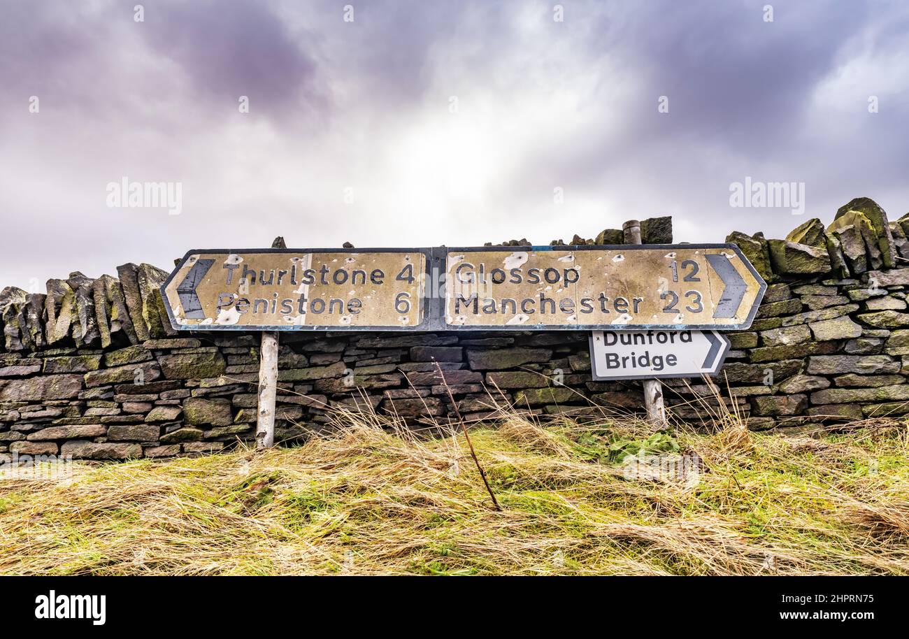 Old weathered sign post to Manchester, Penistone, Glossop, Thurlstone, Stock Photo