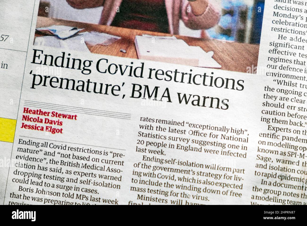 'Ending Covid restrictions 'premature,' BMA warns' Guardian pandemic newspaper headline article clipping cutting on 19 February 2022 London England UK Stock Photo