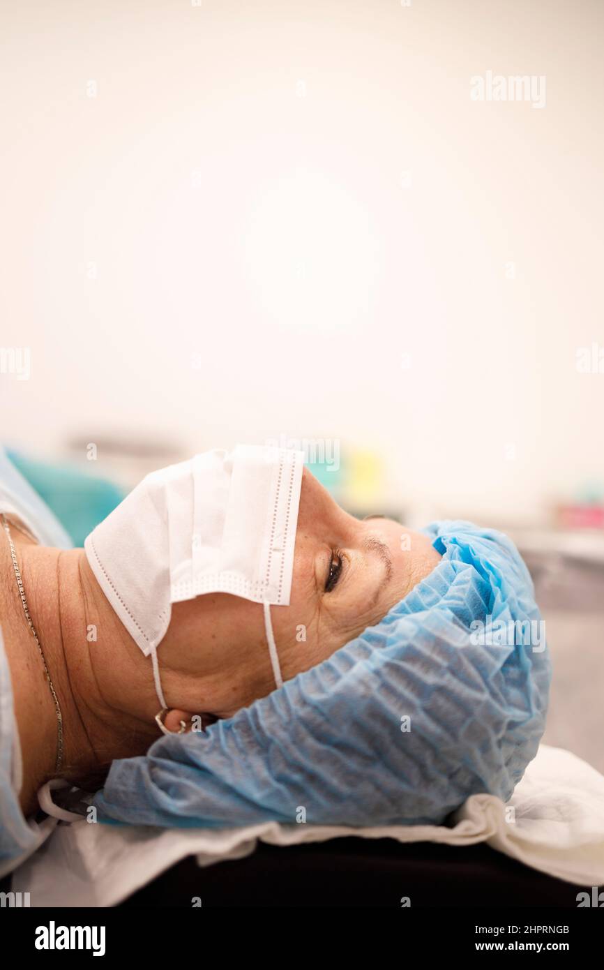 Detail of a senior woman with a face-mask waiting for her surgery Stock Photo