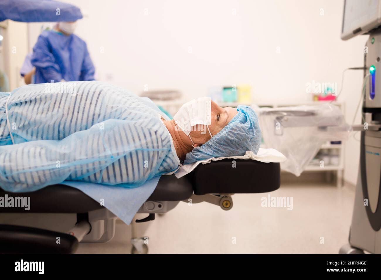 Senior patient lying down and waiting for her cataract surgery Stock Photo