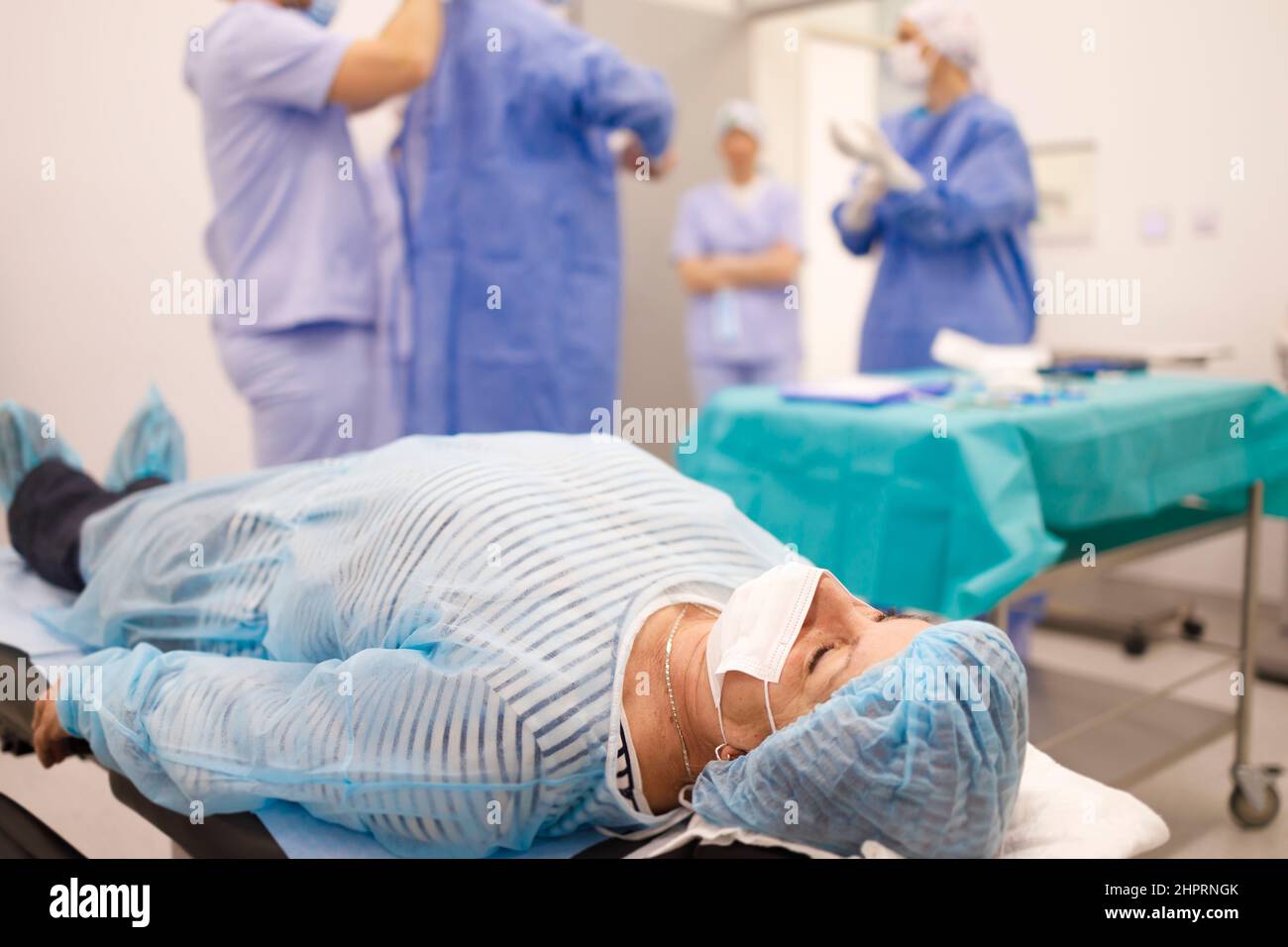 Older woman waiting on a surgery table for her cataract surgery Stock Photo