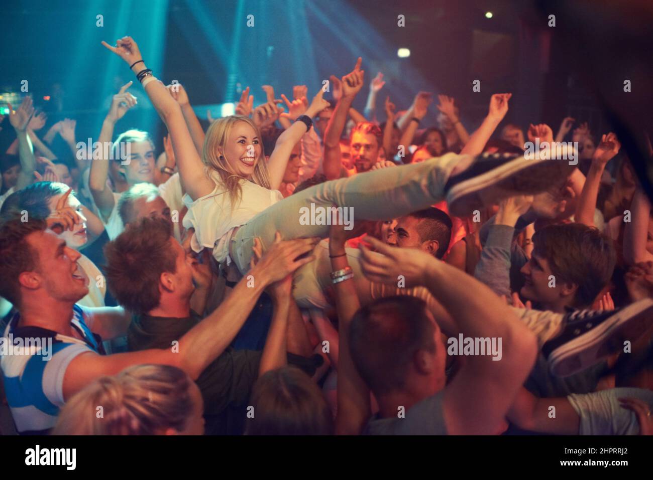 Own the night. Cropped shot of a woman crowd surfing at a music festival. Stock Photo