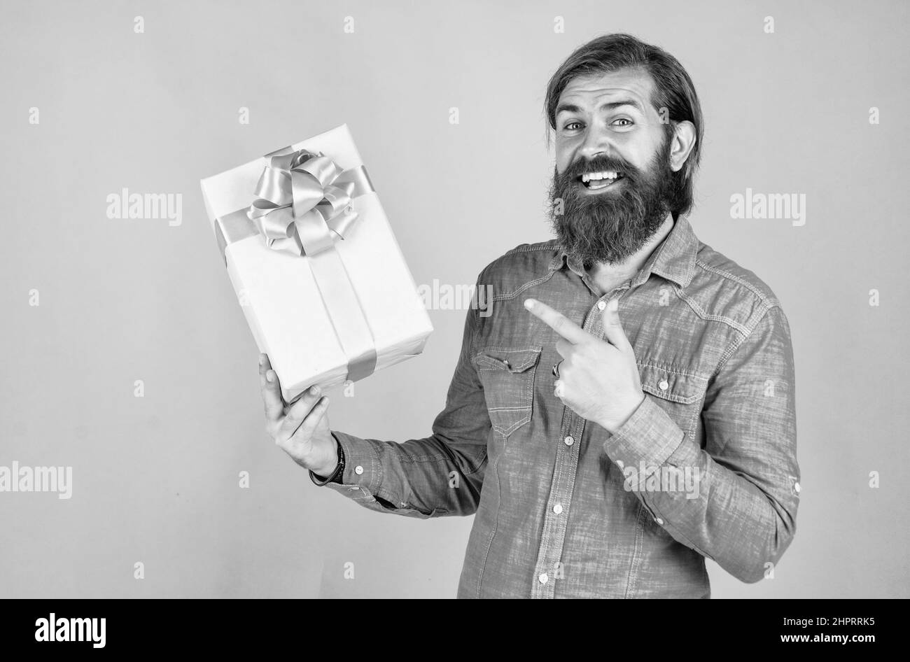 Man Raging Out Gift Holding out gift Black and White Stock Photos & Images - Alamy