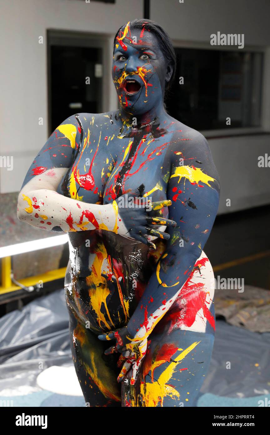 Bodyart artist Jörg Düsterwald has created a series of works of art on the subject of 'diversity' with various photo model types. In the production halls of the cooperating company Vorwerk flooring in Hamelin, he gave the plus-size model Nisi body painting to match the sponsored floor covering and then applied traces of liquid paint. Stock Photo