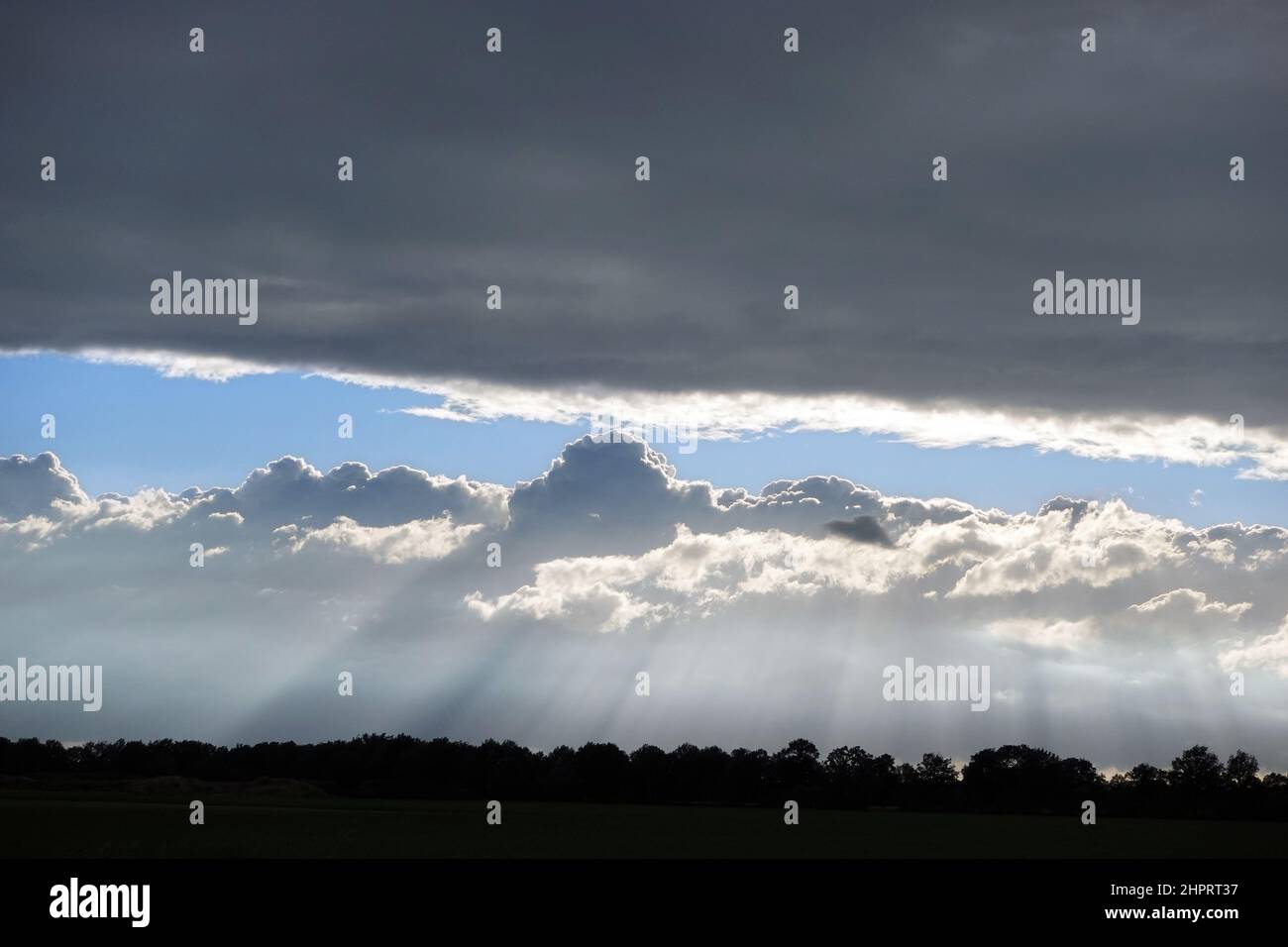 Sky with dark clouds and light streaks Stock Photo