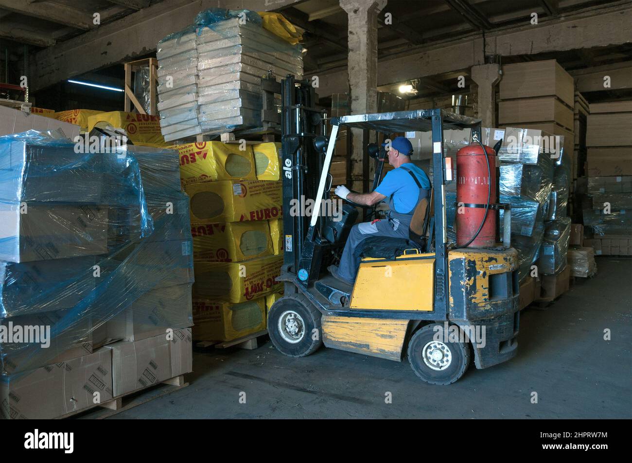 SAINT PETERSBURG, RUSSIA - AUGUST 10, 2021: A forklift truck works at a warehouse of construction materials Stock Photo
