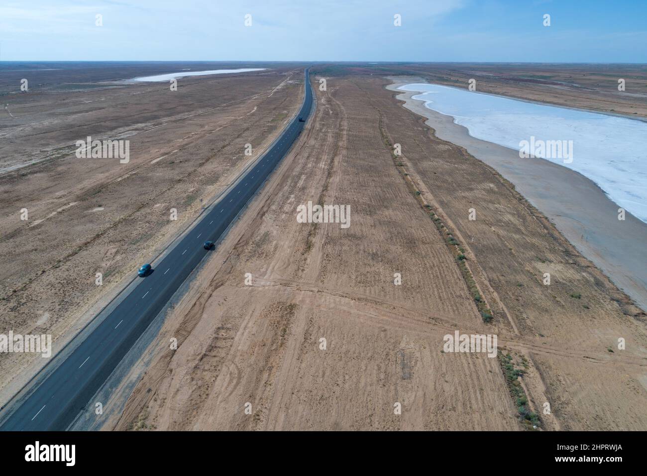 View from a height of the Elista - Astrakhan highway passing between salt lakes. Republic of Kalmykia, Russian Federation Stock Photo