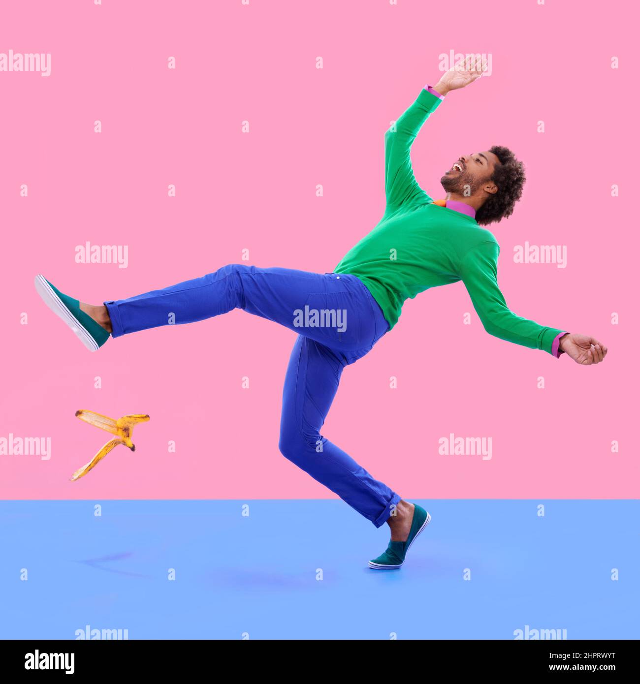 Watch your step.... Humorous shot of a young man slipping on a banana