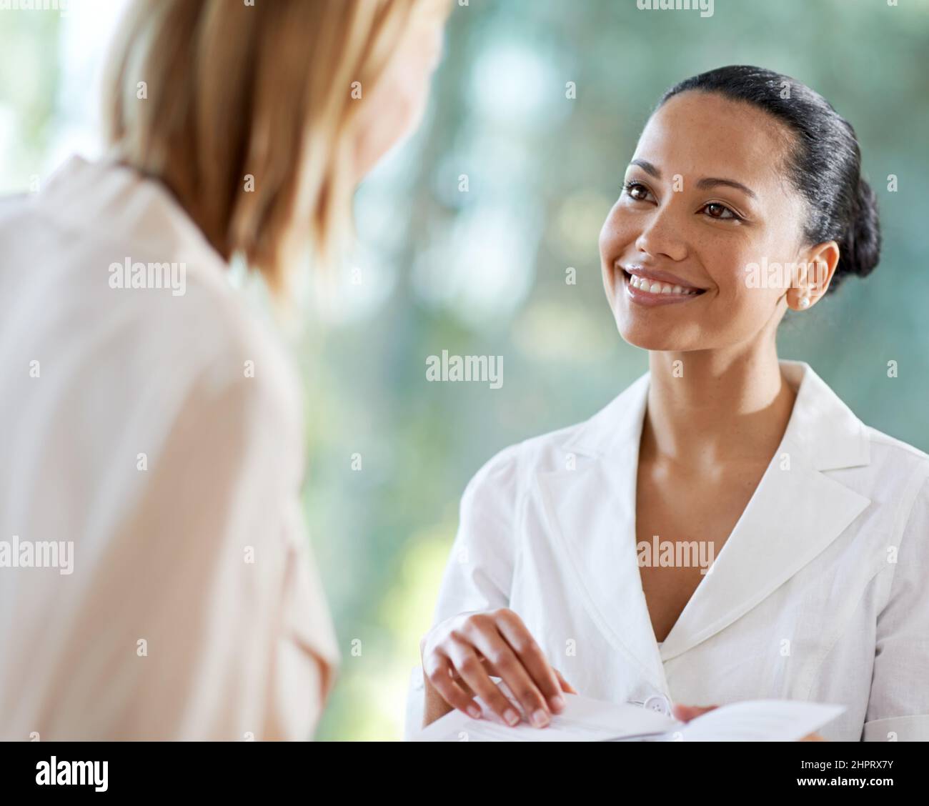 Proud to offer only the best in customer care. Shot of a young woman checking in at the reception desk. Stock Photo