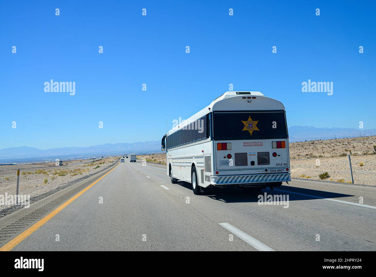 Prisoner correctional transport bus on the road in Nevada Stock Photo