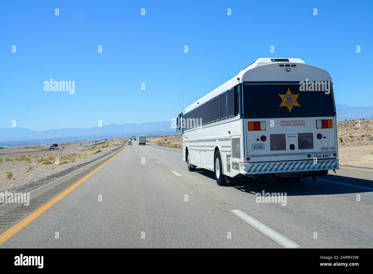 Prisoner correctional transport bus on the road in Nevada Stock Photo