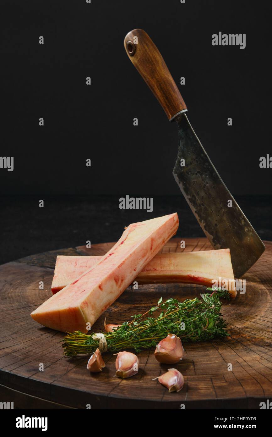 Raw beef bone marrow chopped on half on wooden stub Stock Photo Alamy