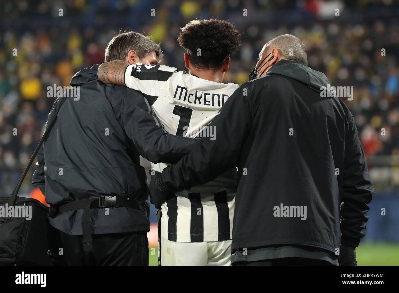 Villarreal, Spain, 22nd February 2022. Weston McKennie of Juventus reacts as he is accompanied from the field of play by Nikos Tzouroudis Juventus First Team Doctor ( right ) and Phyisiotherapist Francesco Pieralisi ( left ) after picking up a serious foot injury following a challenge by Pervis Estupinan of Villarreal CF during the UEFA Champions League match at Estadio de la Ceramica, Villarreal. Picture credit should read: Jonathan Moscrop / Sportimage Stock Photo