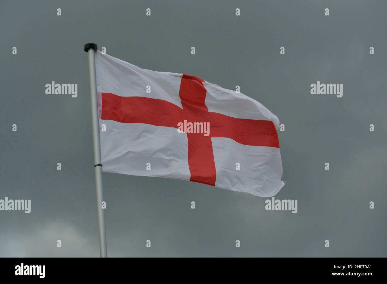 St George's Cross England's National Flag - Waving In the Wind - Red + White Flag - Dark Sky - Yorkshire - UK Stock Photo