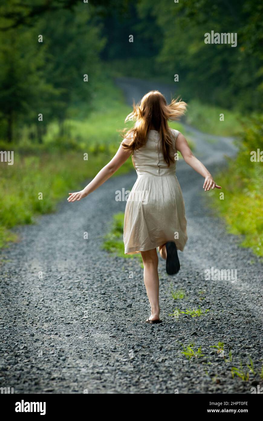 Woman running away dress vertical hi-res stock photography and images -  Alamy