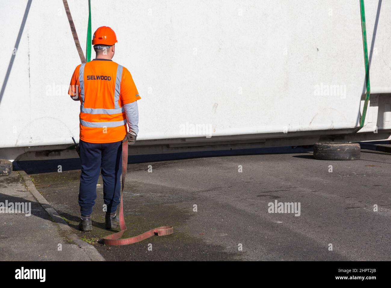 Selwood worker holding belt support around swimming pool Stock Photo
