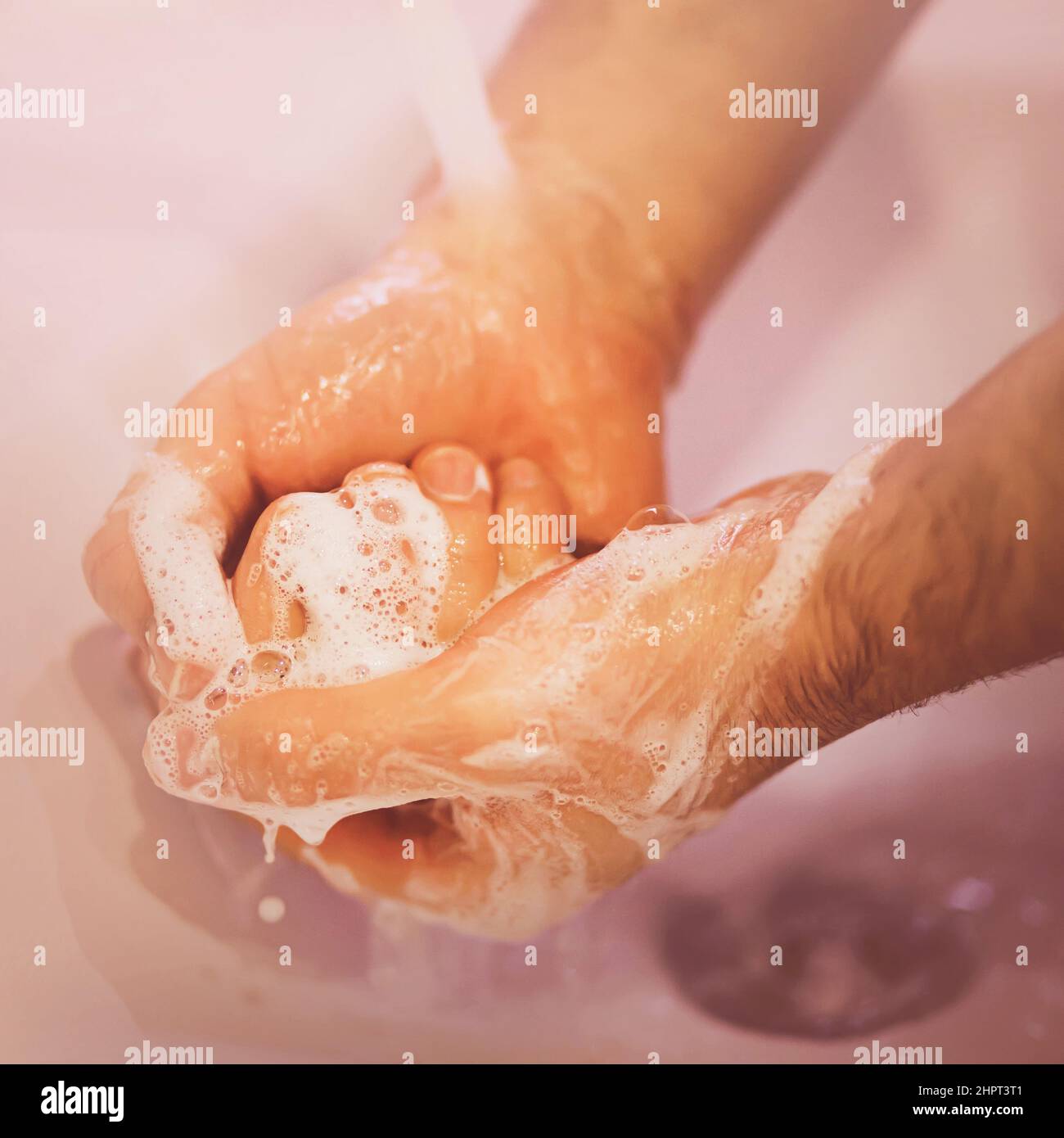 Bucket full of soap suds and hand washing Stock Photo - Alamy