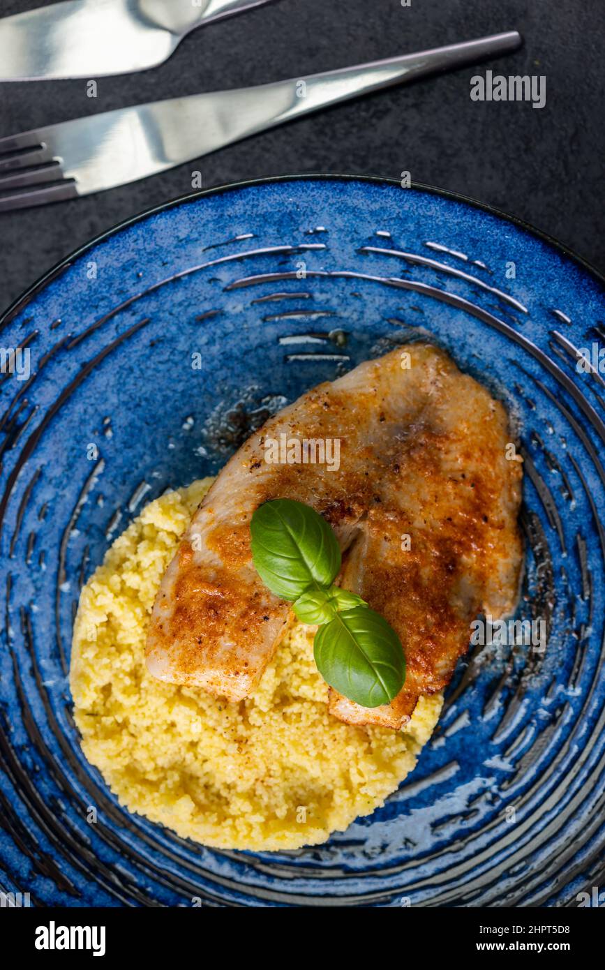 spicy fillet of white cod with couscous Stock Photo Alamy