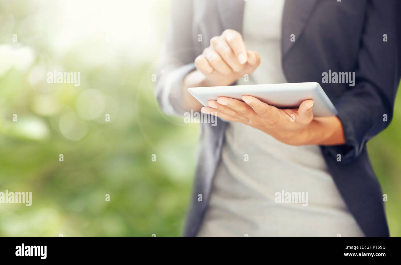 Doing business the modern way. A cropped image of a businesswoman working on a digital tablet. Stock Photo