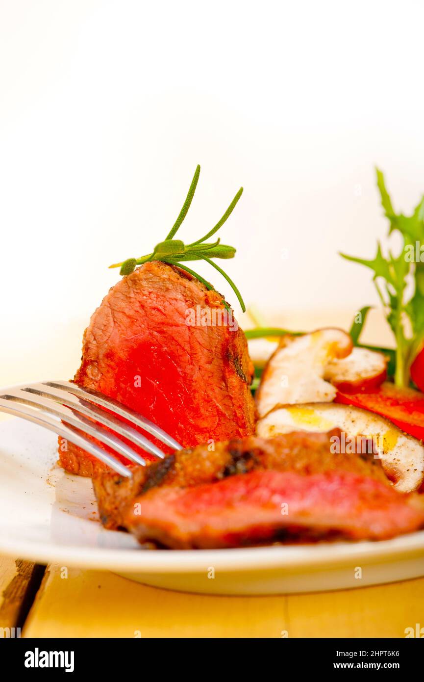 beef filet mignon grilled with fresh vegetables on side ,mushrooms